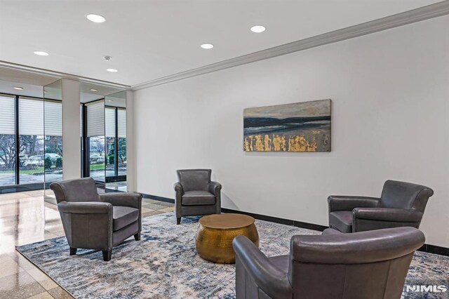 building lobby featuring recessed lighting, ornamental molding, and a wall of windows