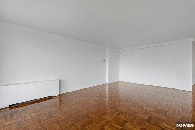 spare room featuring baseboards