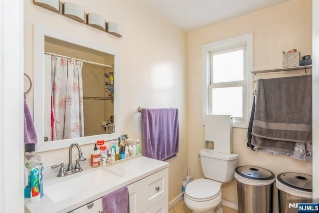 bathroom with vanity, curtained shower, and toilet
