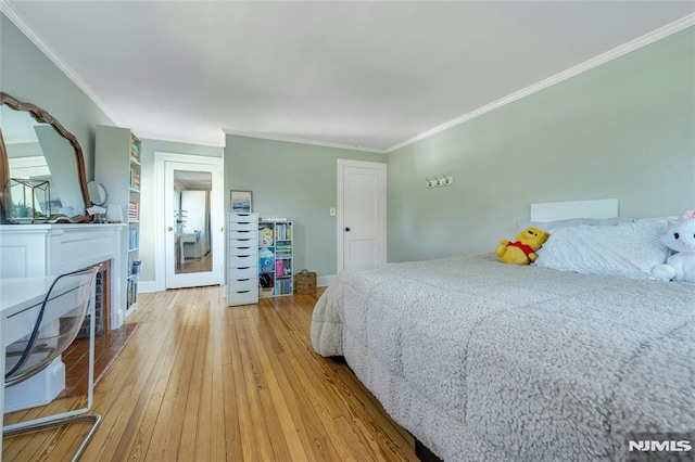 400 Prospect Ave, Oradell, NJ 07649 - bedroom with wood-type flooring, ornamental molding, and a glass covered fireplace
