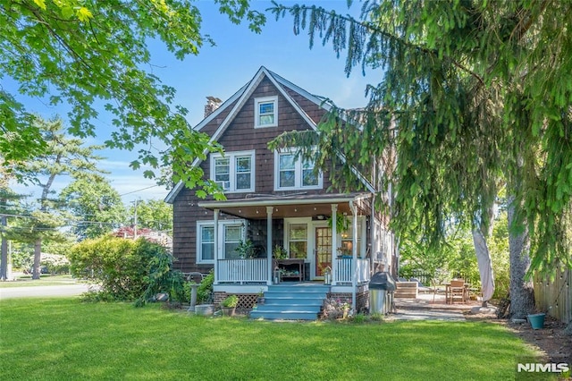 400 Prospect Ave, Oradell, NJ 07649 - view of front of home featuring a chimney, a front lawn, and a porch