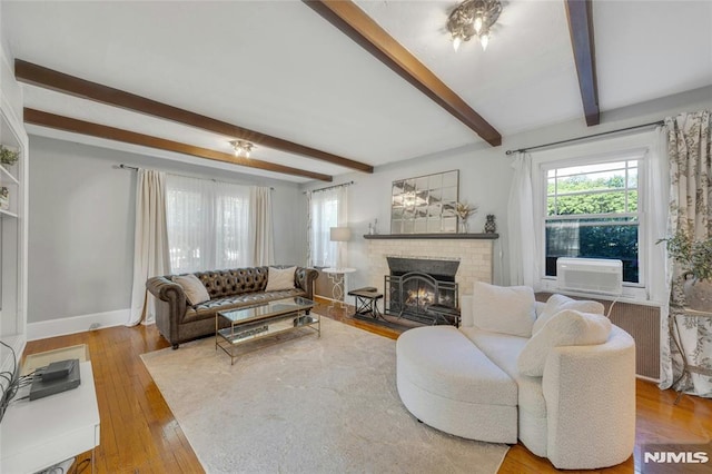 400 Prospect Ave, Oradell, NJ 07649 - living room with beamed ceiling, healthy amount of natural light, a brick fireplace, hardwood / wood-style floors, and baseboards