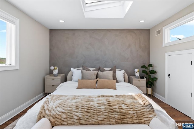 bedroom featuring recessed lighting, baseboards, visible vents, an accent wall, and a skylight