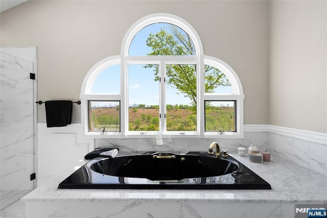 bathroom with a garden tub