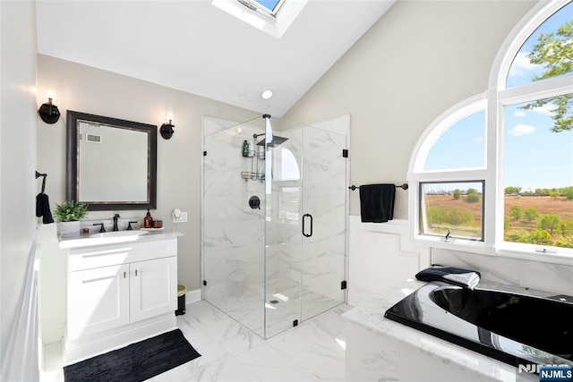 bathroom featuring a garden tub, a wealth of natural light, a marble finish shower, and marble finish floor