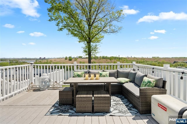 deck with outdoor dining space and outdoor lounge area