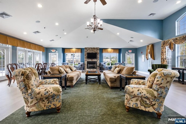 living area featuring visible vents, ceiling fan with notable chandelier, and recessed lighting