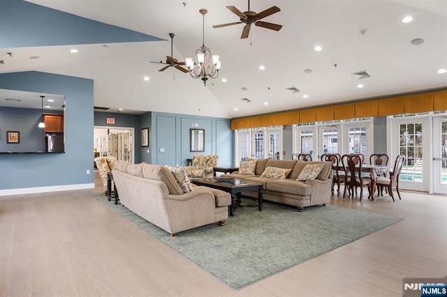 living room with light wood-style floors, visible vents, ceiling fan with notable chandelier, and recessed lighting