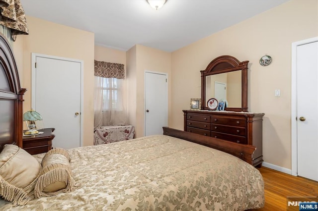 bedroom featuring wood finished floors and baseboards