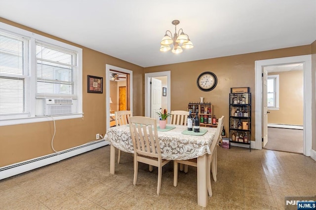 dining space featuring a baseboard heating unit, a chandelier, cooling unit, and baseboards