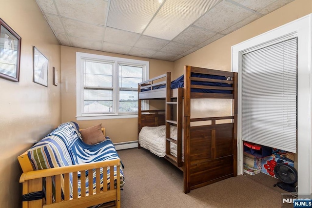 bedroom featuring baseboard heating, carpet, and a paneled ceiling