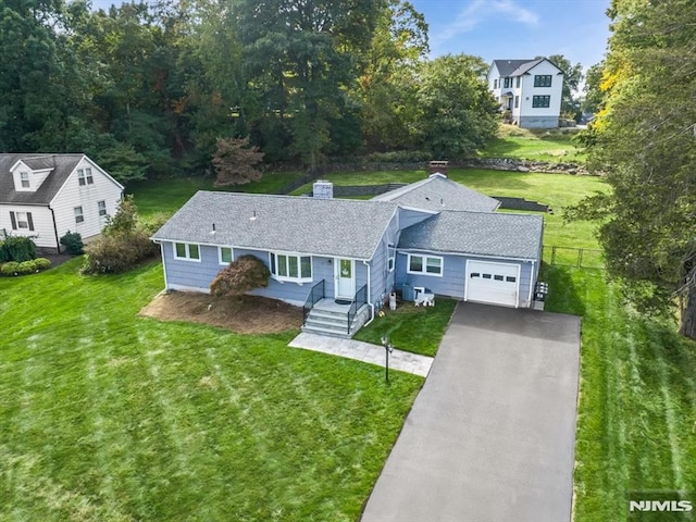 view of front facade with a garage, asphalt driveway, and a shingled roof
