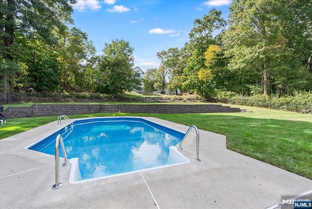 view of swimming pool with a lawn and a patio area