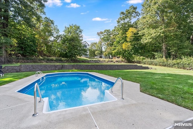 view of swimming pool featuring a yard and a patio