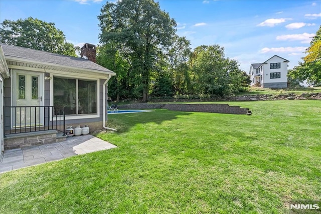 view of grassy yard featuring an outdoor pool