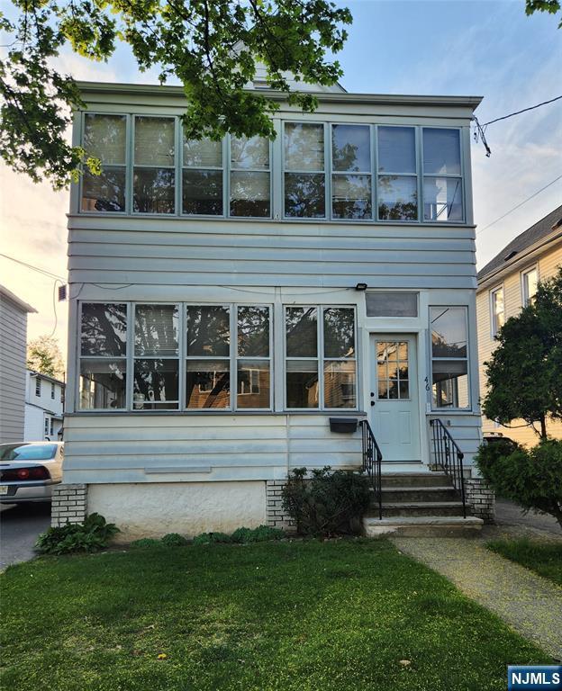 46 High St, Clifton, NJ 07014 - view of front facade with entry steps and a front lawn