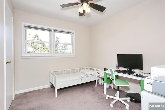 carpeted bedroom featuring baseboards and a ceiling fan