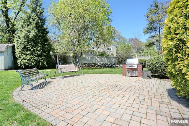 view of patio featuring a grill, an outdoor structure, a storage shed, and fence