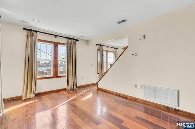 spare room with baseboards, a healthy amount of sunlight, and visible vents
