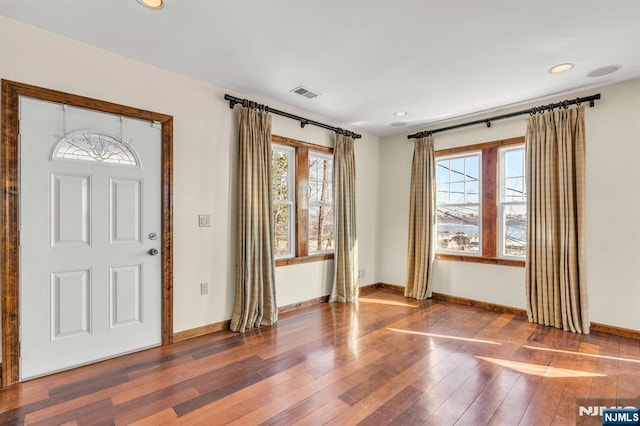 entryway with visible vents, baseboards, wood-type flooring, and recessed lighting