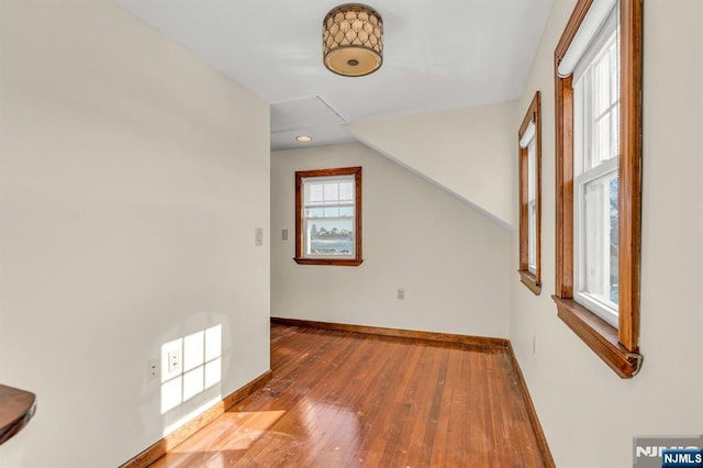 bonus room featuring baseboards and hardwood / wood-style floors