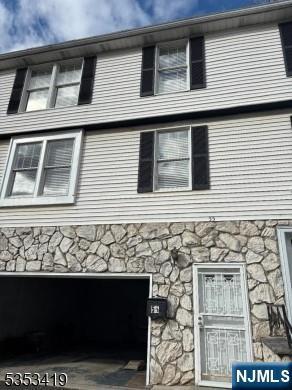 55 2nd St, South Orange Village, NJ 07079 - view of side of home with stone siding and a garage