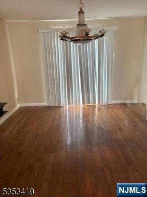 55 2nd St, South Orange Village, NJ 07079 - unfurnished dining area featuring a chandelier, wood-type flooring, and baseboards