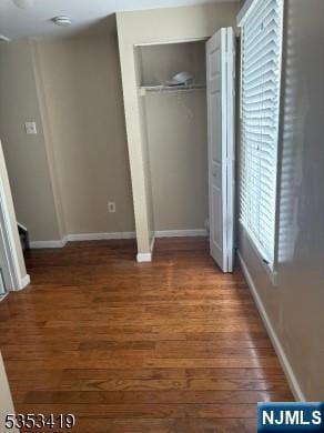 55 2nd St, South Orange Village, NJ 07079 - unfurnished bedroom with wood finished floors, baseboards, and a closet