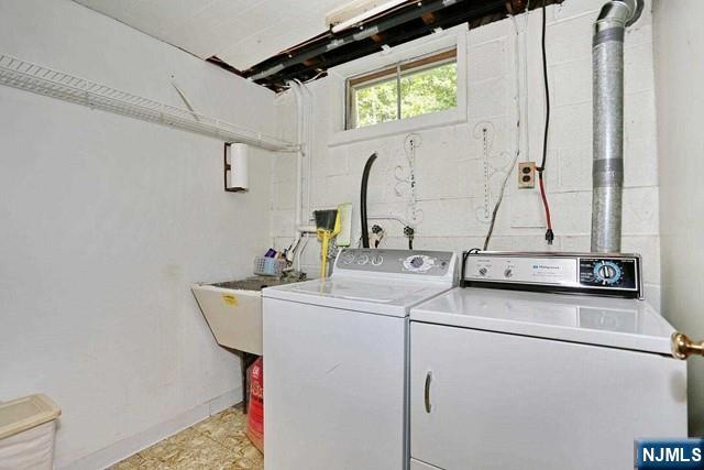 laundry room featuring separate washer and dryer and laundry area