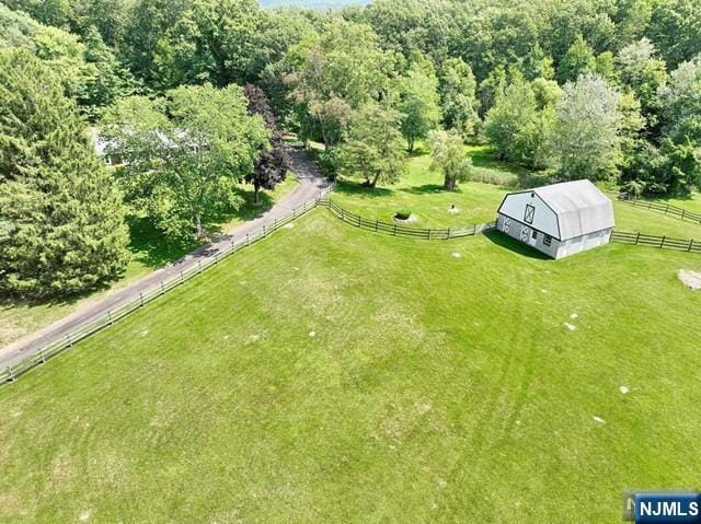 bird's eye view with a wooded view