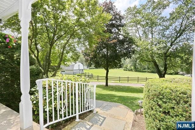 view of yard featuring fence and a barn
