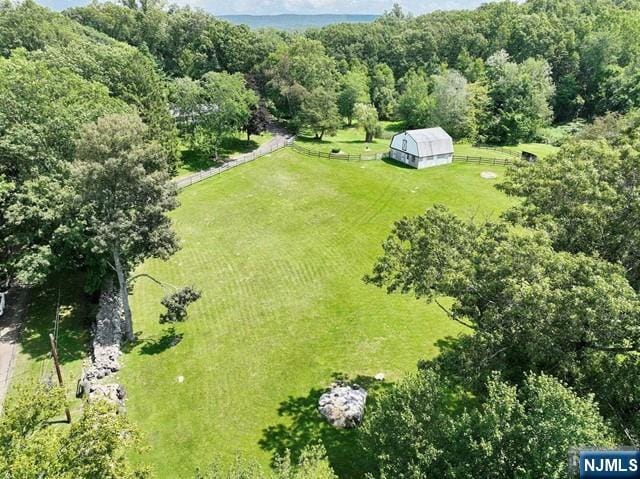 drone / aerial view featuring a wooded view and a rural view