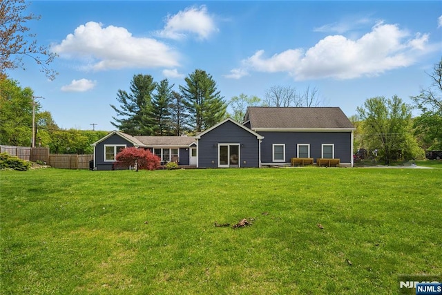 view of front of home with fence and a front yard
