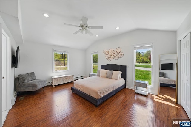 bedroom with a baseboard radiator, lofted ceiling, recessed lighting, and wood finished floors