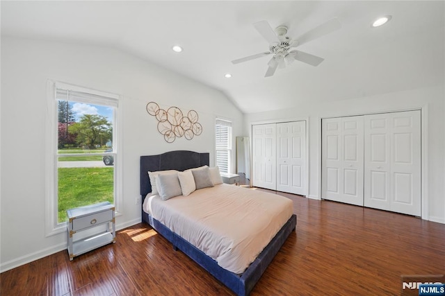 bedroom with lofted ceiling, recessed lighting, multiple closets, and wood finished floors
