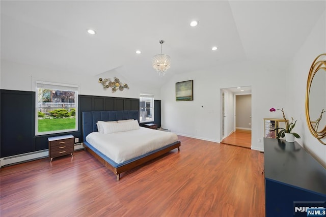 bedroom featuring an inviting chandelier, wood finished floors, baseboards, baseboard heating, and lofted ceiling