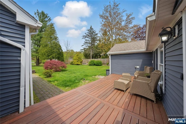 wooden terrace with fence and a lawn