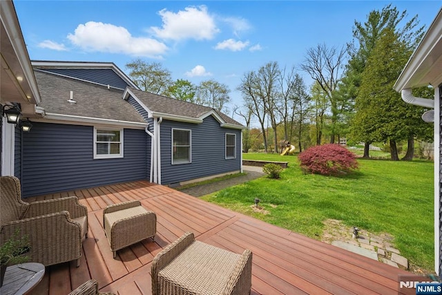 wooden terrace featuring a yard