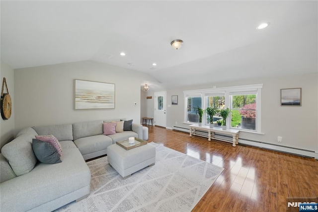 living area featuring wood finished floors, lofted ceiling, a baseboard heating unit, and recessed lighting