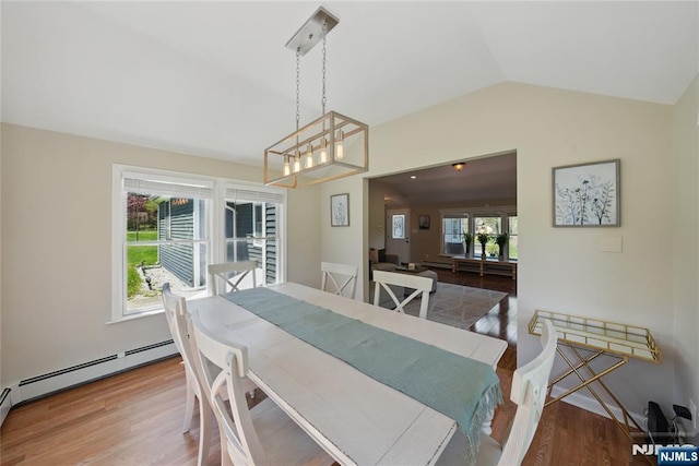 dining room featuring a baseboard radiator, lofted ceiling, an inviting chandelier, and wood finished floors