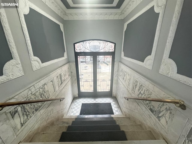 foyer entrance featuring wainscoting and french doors