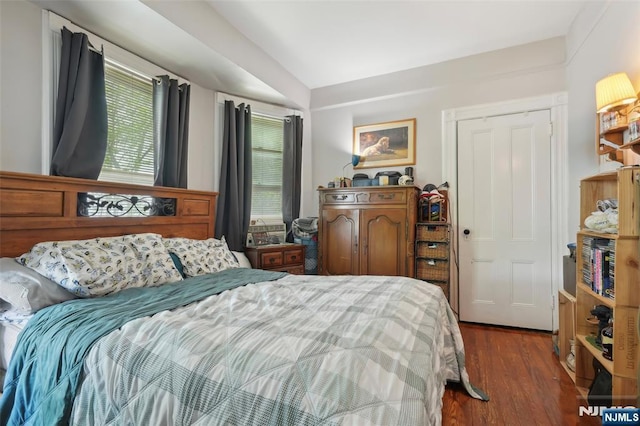 bedroom with dark wood-style floors
