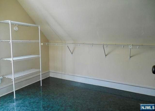walk in closet with vaulted ceiling