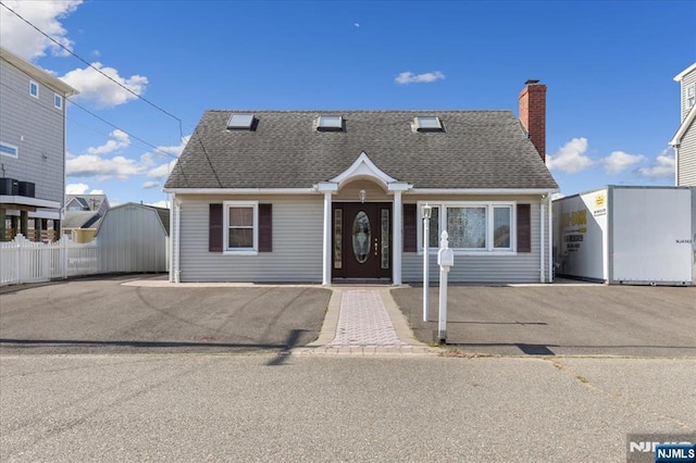234 Cedar Dr, Berkeley, NJ 08721 - view of front of home featuring a chimney, fence, and a shingled roof