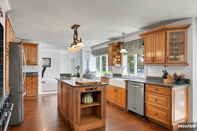 kitchen featuring a sink, stainless steel appliances, open shelves, and dark wood finished floors
