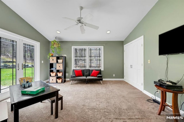 interior space with ceiling fan, lofted ceiling, carpet, and plenty of natural light