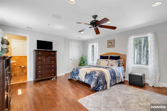 bedroom with wood finished floors, a ceiling fan, visible vents, baseboards, and recessed lighting
