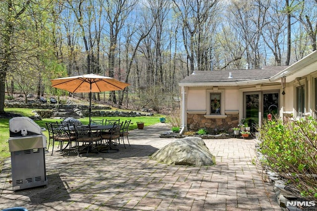 view of patio with outdoor dining space and grilling area