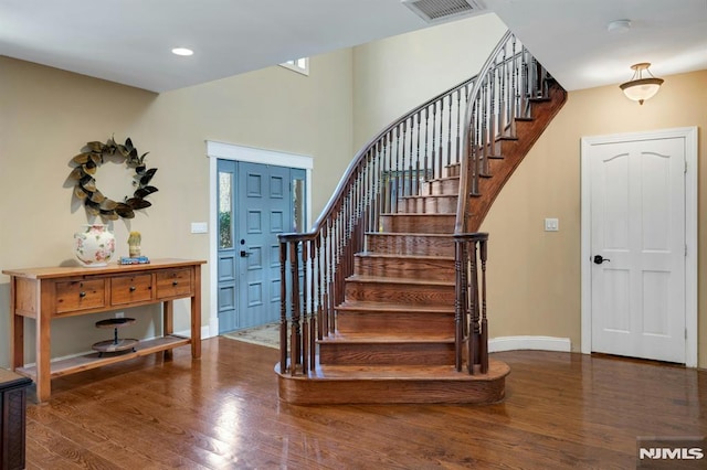 stairs featuring baseboards, recessed lighting, visible vents, and wood finished floors