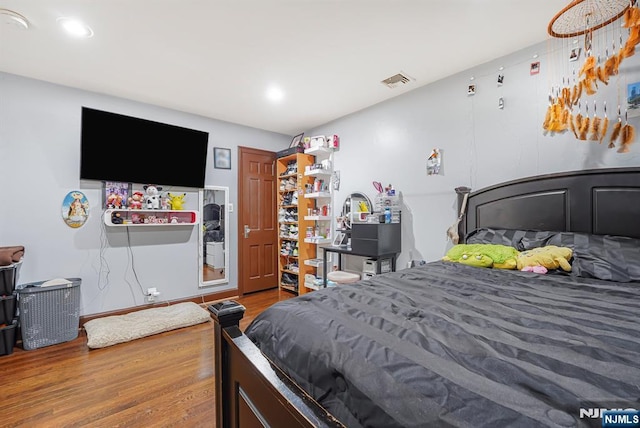 bedroom featuring recessed lighting, visible vents, and wood finished floors